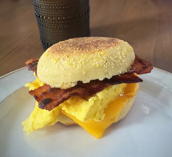 Bacon, egg, and cheese breakfast sandwich on a homemade English muffin