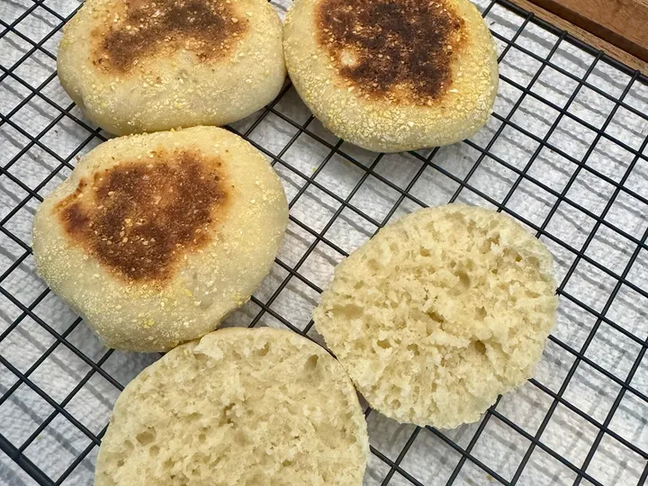 Fresh English muffins cooling on a wire rack