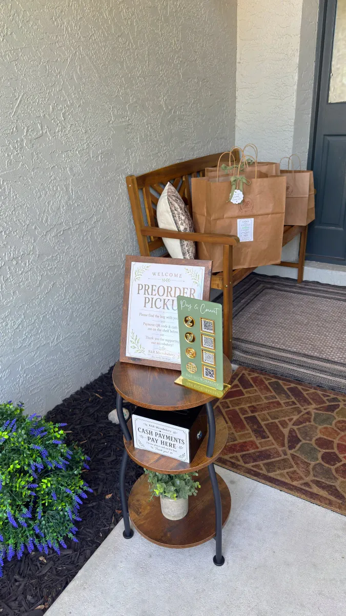 Prepared R&R Microbakery preorder bags waiting beside the porch pickup sign